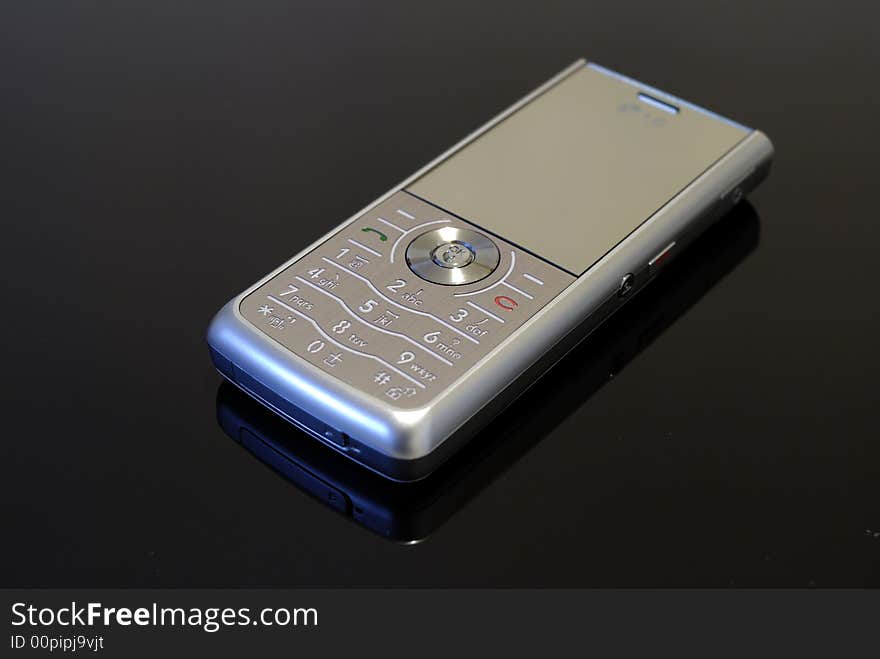 Silver mobile phone in black background. Silver mobile phone in black background.