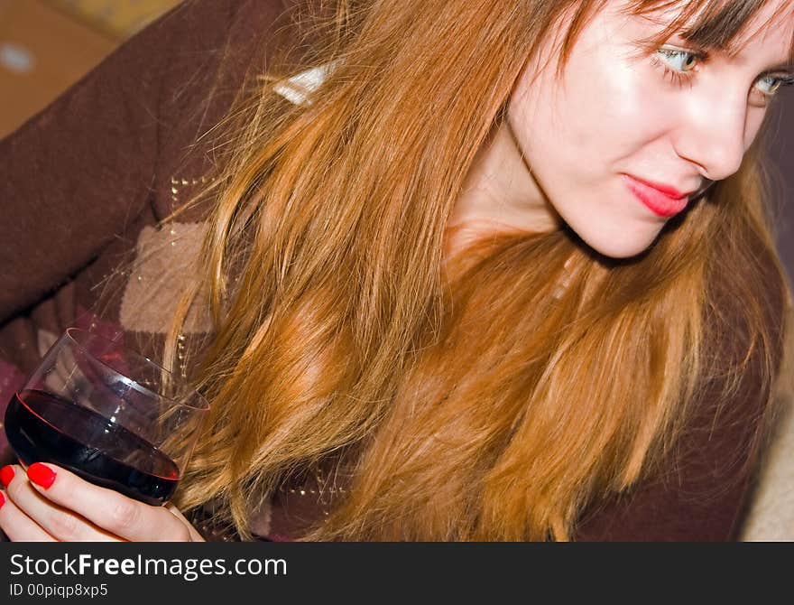 Pretty girl relaxed having a drink at home