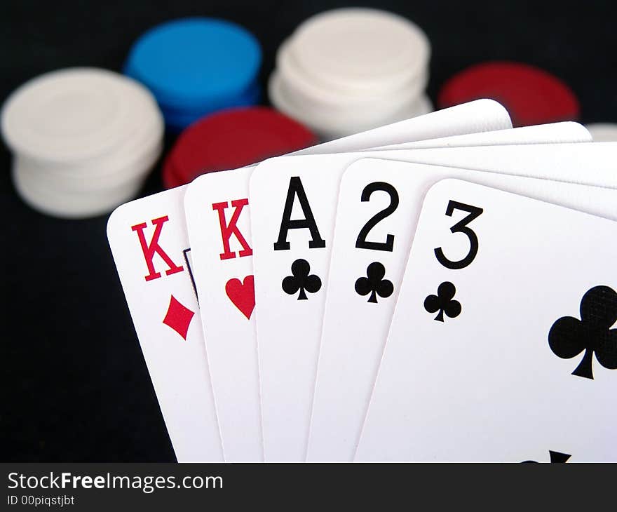 Cards in foreground with poker chips in background. Cards in foreground with poker chips in background