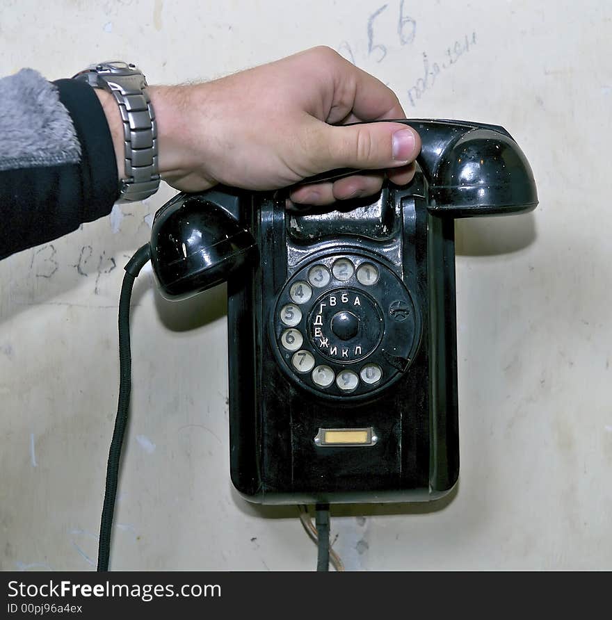 Hand holding a tube of old phone