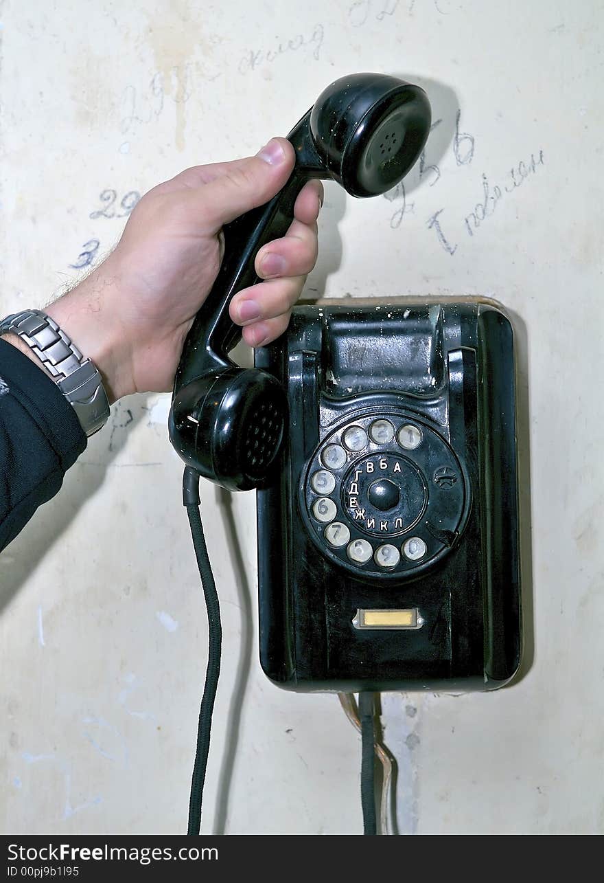 Hand holding a tube of old phone