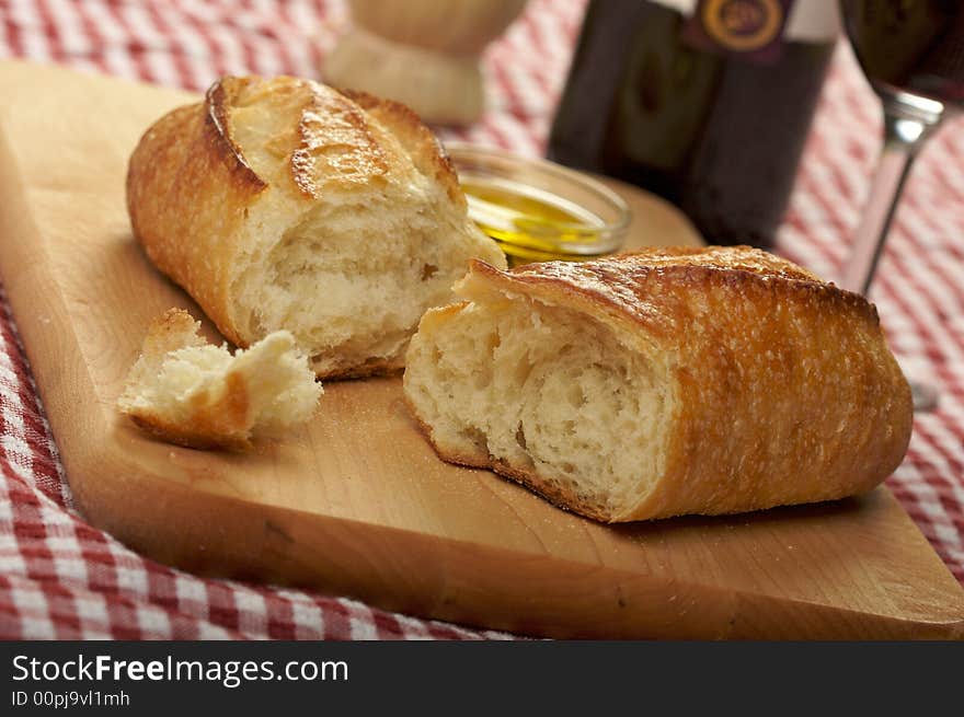 Sourdough Bread & Cutting Board on red & white checkered gingham - Narrow Depth of Field. Sourdough Bread & Cutting Board on red & white checkered gingham - Narrow Depth of Field