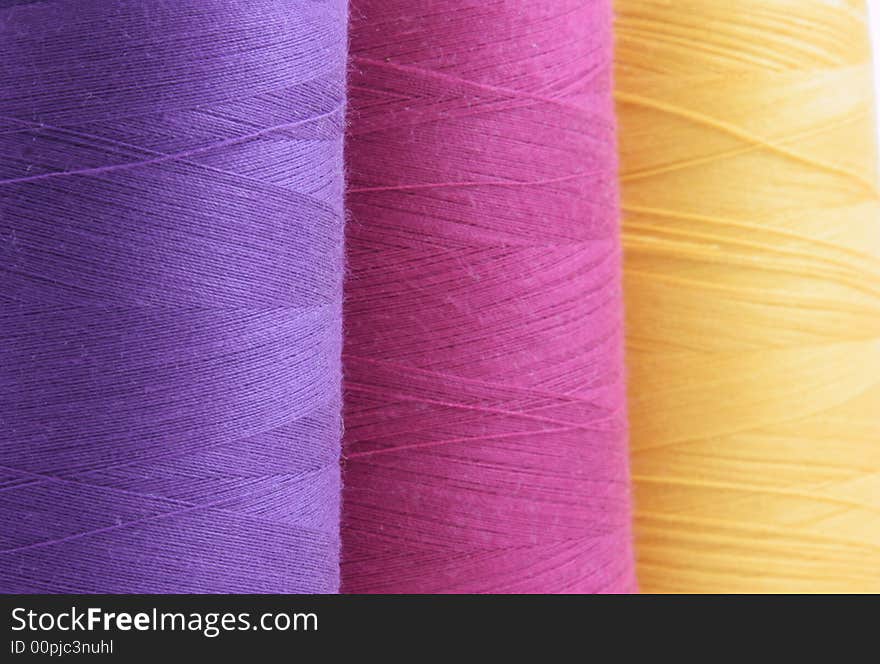 Colored spools of thread close-up isolated