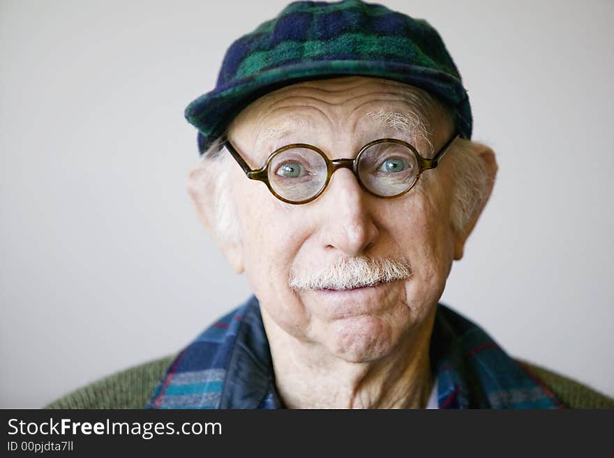 Senior Man In A Hat And Glasses