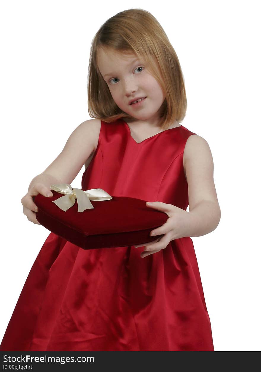 Young girl holding a heart valentine box of chocolates. Young girl holding a heart valentine box of chocolates