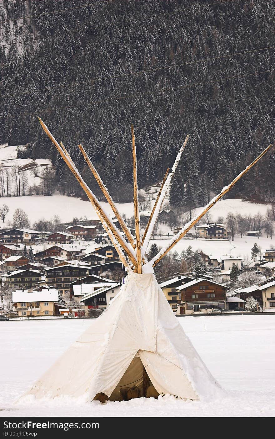 White tipi covered in snow, detail taken in the skiing resort Soell in Alps. White tipi covered in snow, detail taken in the skiing resort Soell in Alps