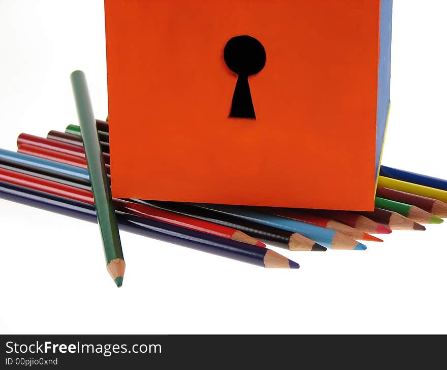 Close up to a handmade wooden box with a key hole on wood crayons