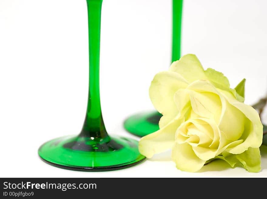 Yellow rose and two green glasses. Yellow rose and two green glasses