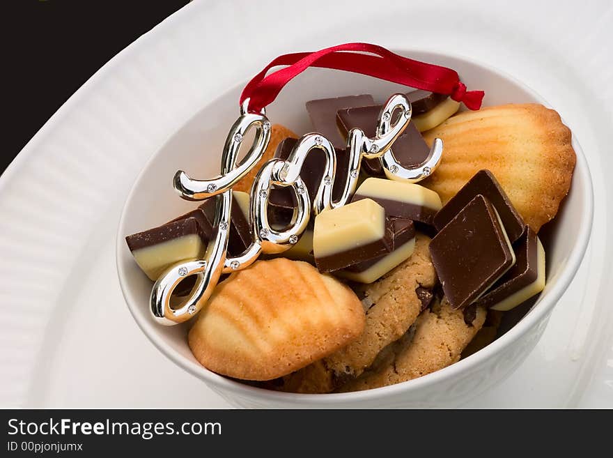 Plate with cookies and chocolates with the love charm