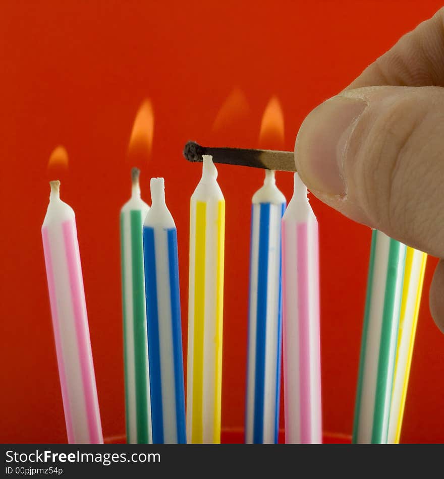 Studio close up of lighting birthday candles