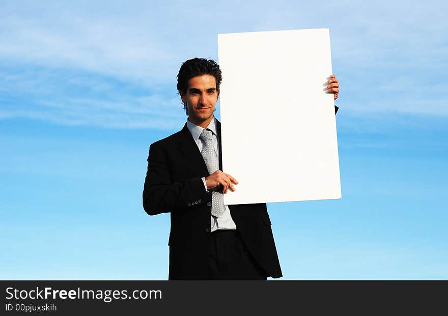 Businessman holding blank board