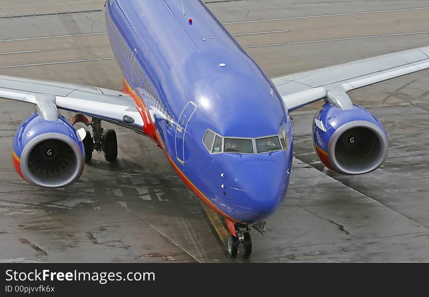 A passenger jet pulling into from the gate. A passenger jet pulling into from the gate