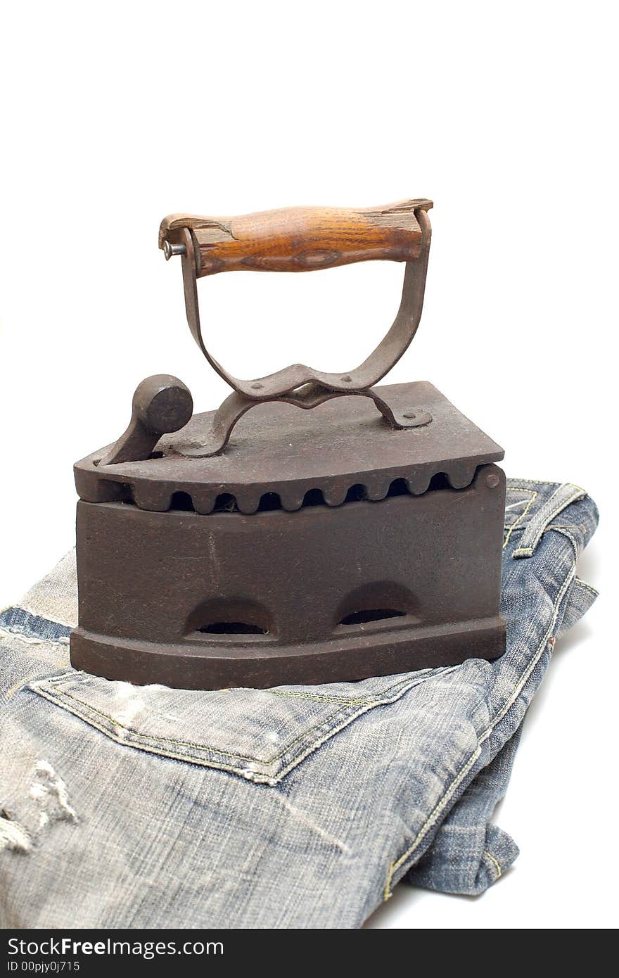 Old vintage flat-iron with jeans vertical. Old vintage flat-iron with jeans vertical