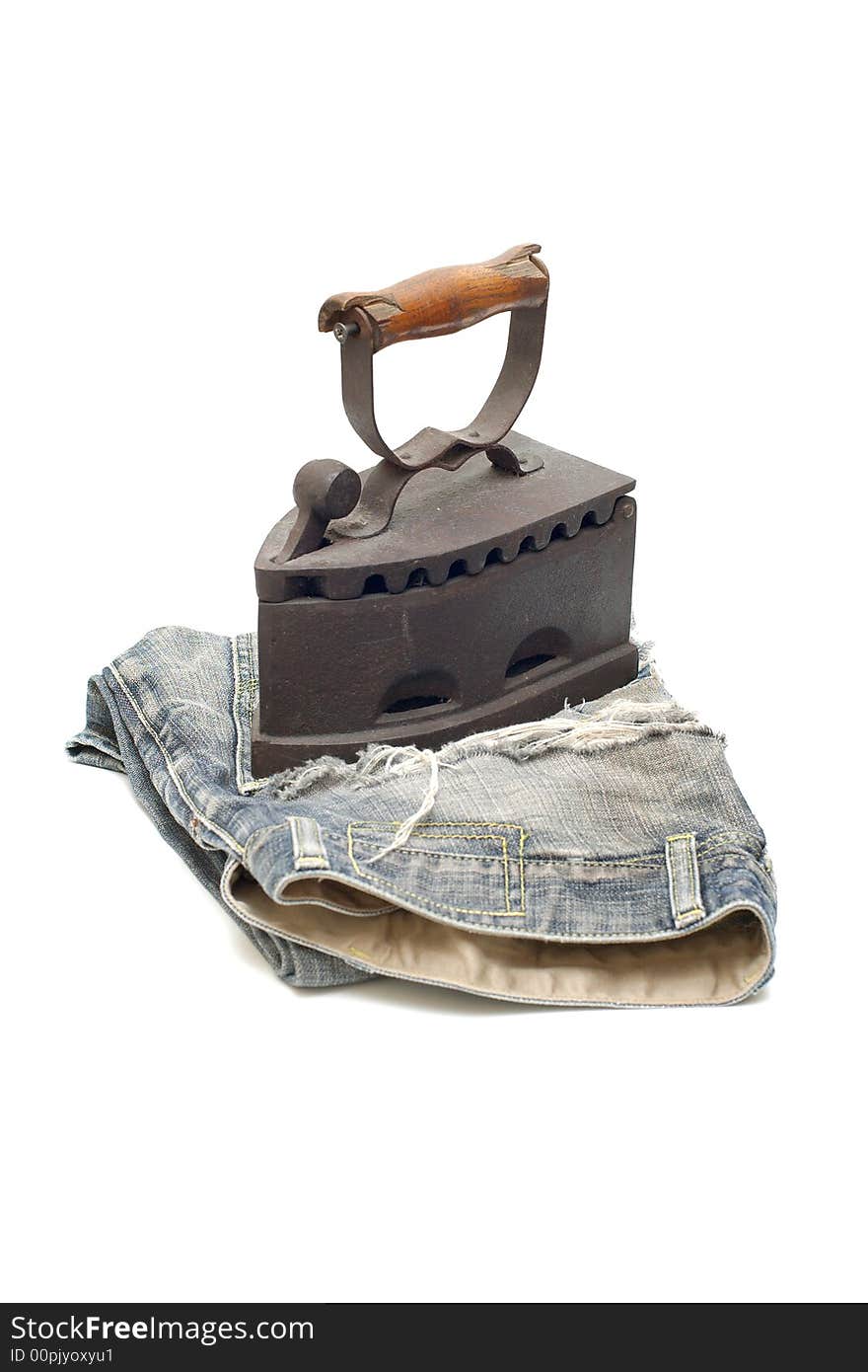 Old vintage flat-iron with jeans vertical. Old vintage flat-iron with jeans vertical