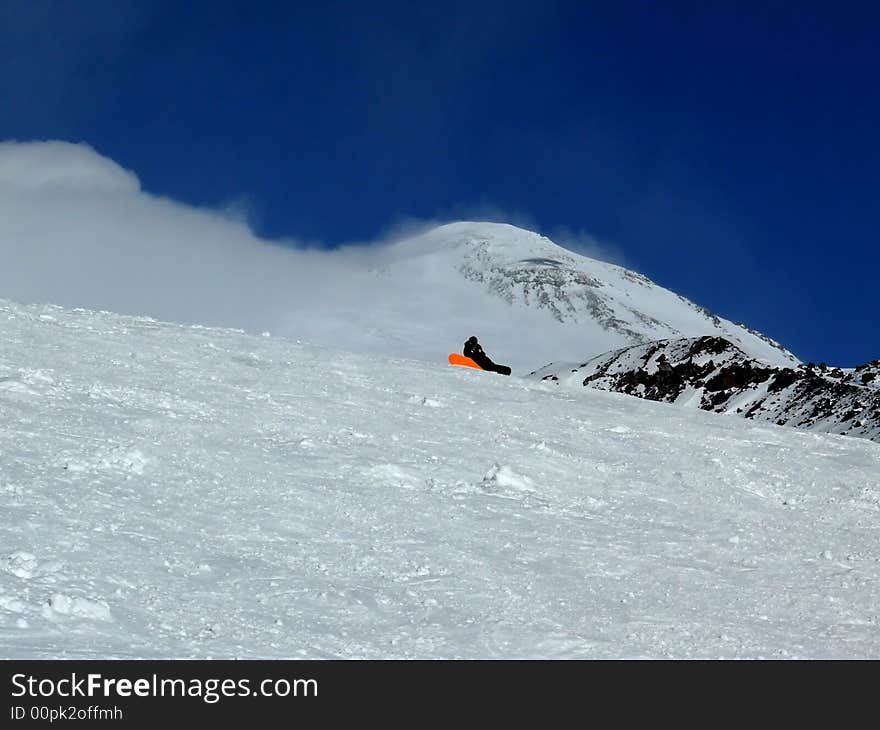 Snowboarder at the rest on the Ski Resort. Russia, Elbrus. Snowboarder at the rest on the Ski Resort. Russia, Elbrus