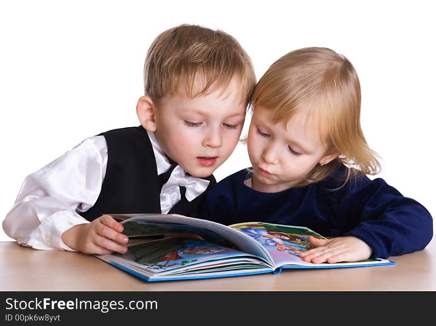 Young girl and boy look the book