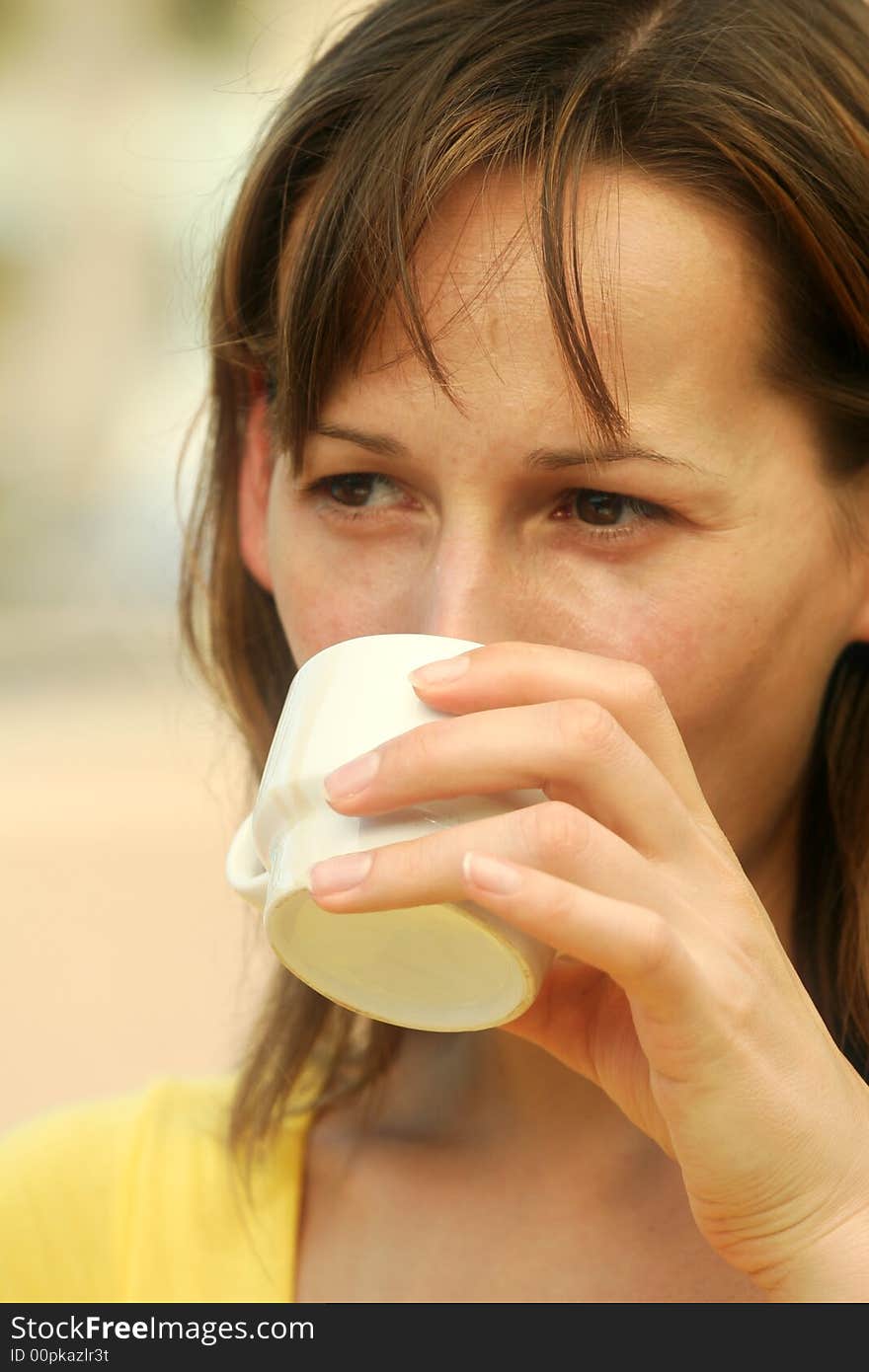 Woman drinking coffee in outdoor restaurant