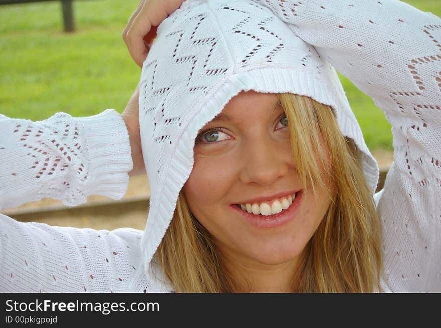 Pretty girl laughing in a white hood. Pretty girl laughing in a white hood