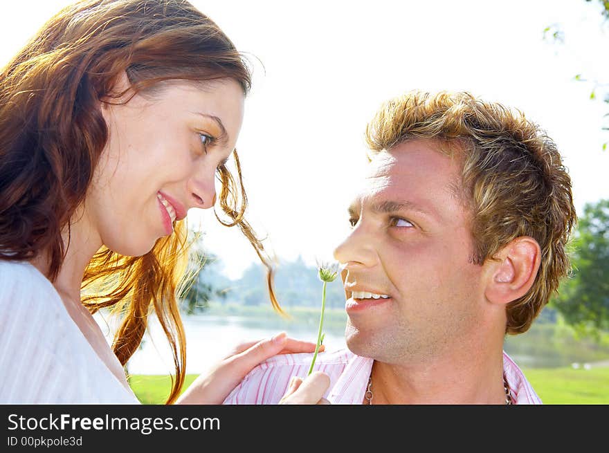 A portrait of attractive couple in summer environment. A portrait of attractive couple in summer environment