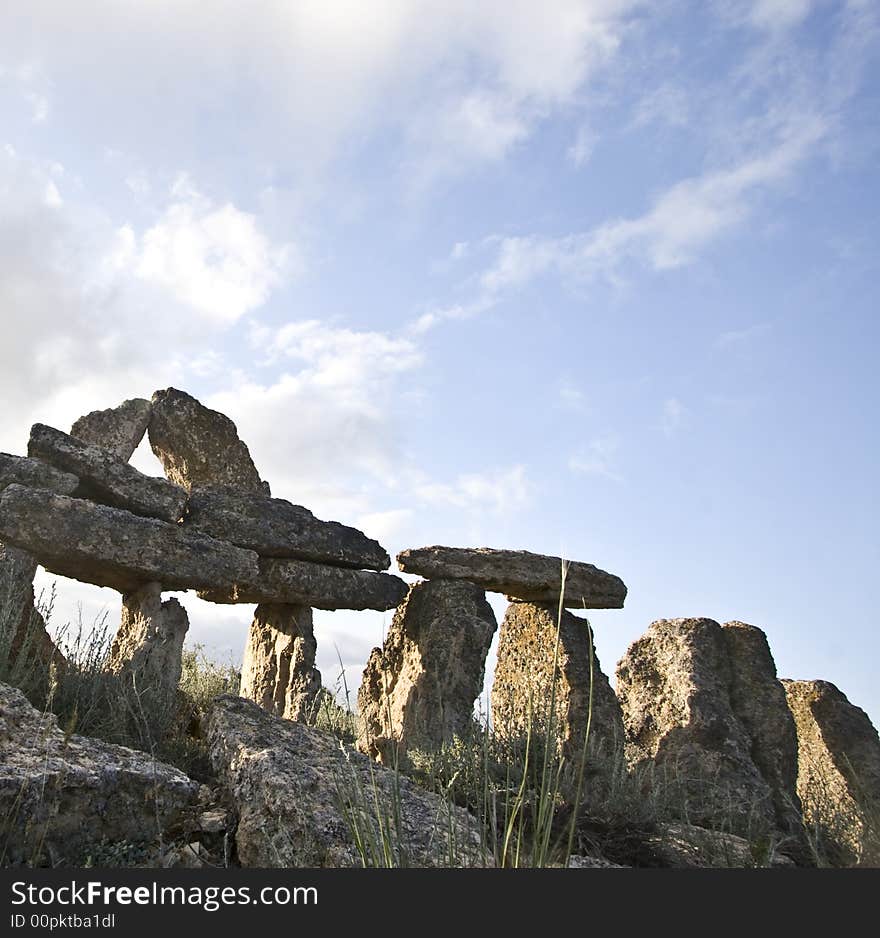 Stonehenge in Mangistau region. Kazakhstan. Expansive view of replica of Stonehenge with a beautiful blue sky and clouds in the background.