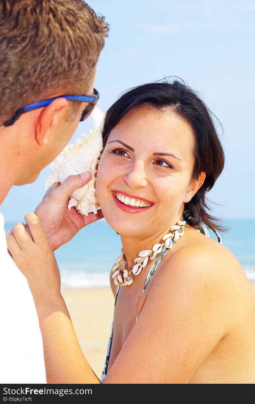 A portrait of attractive couple having fun on the beach. A portrait of attractive couple having fun on the beach