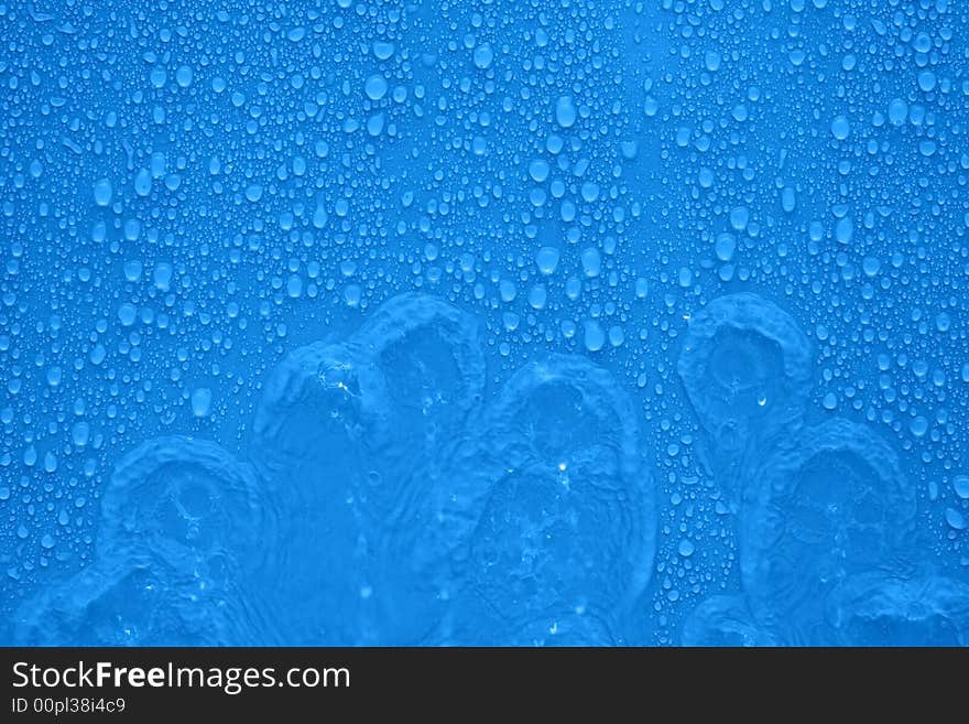 Water drops and streams over blue background