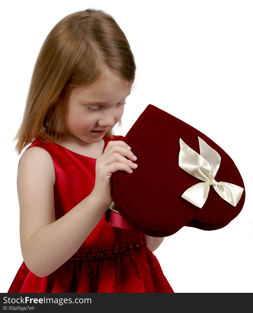 Young girl holding a heart valentine box of chocolates. Young girl holding a heart valentine box of chocolates