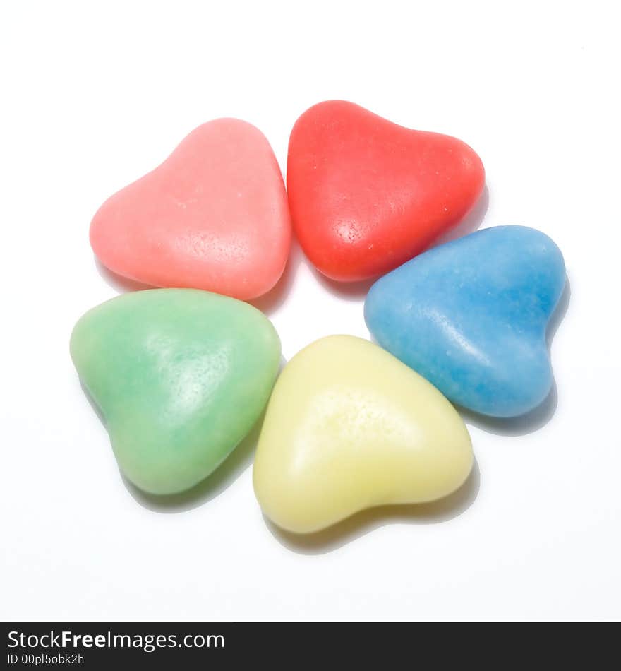 Five heart colourful shaped candy's in a circle. Five heart colourful shaped candy's in a circle