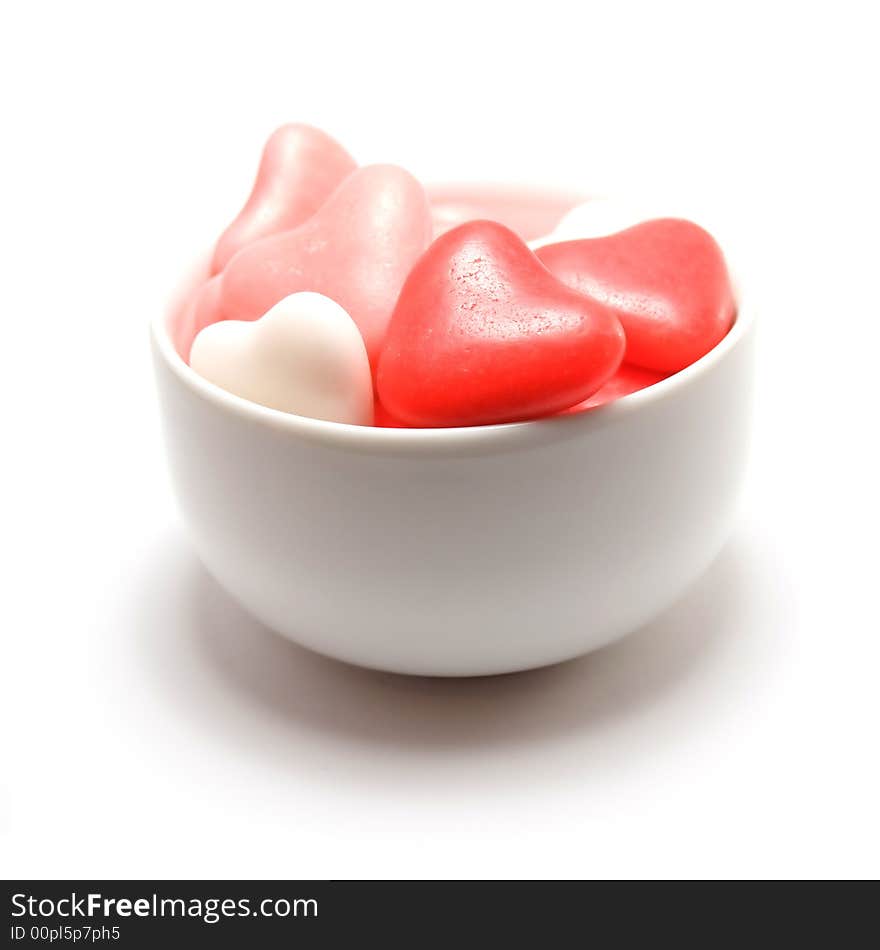 Bowl of heart shaped candy isolated on a white background. Bowl of heart shaped candy isolated on a white background