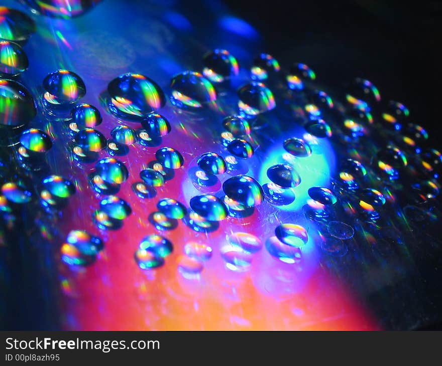 Macro picture of water drops on a cd disc.