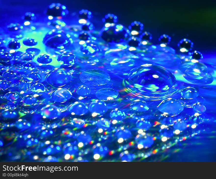 Macro picture of water drops on a cd disc.