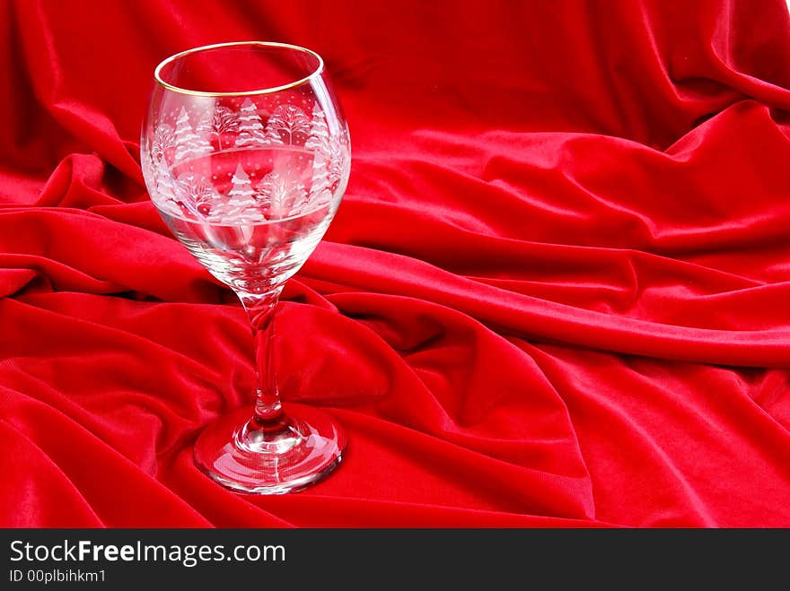 Empty wine glass on red velvet