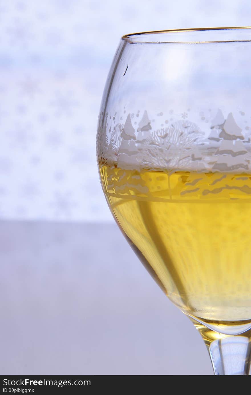 Golden wine in glass close up on pale background. Golden wine in glass close up on pale background