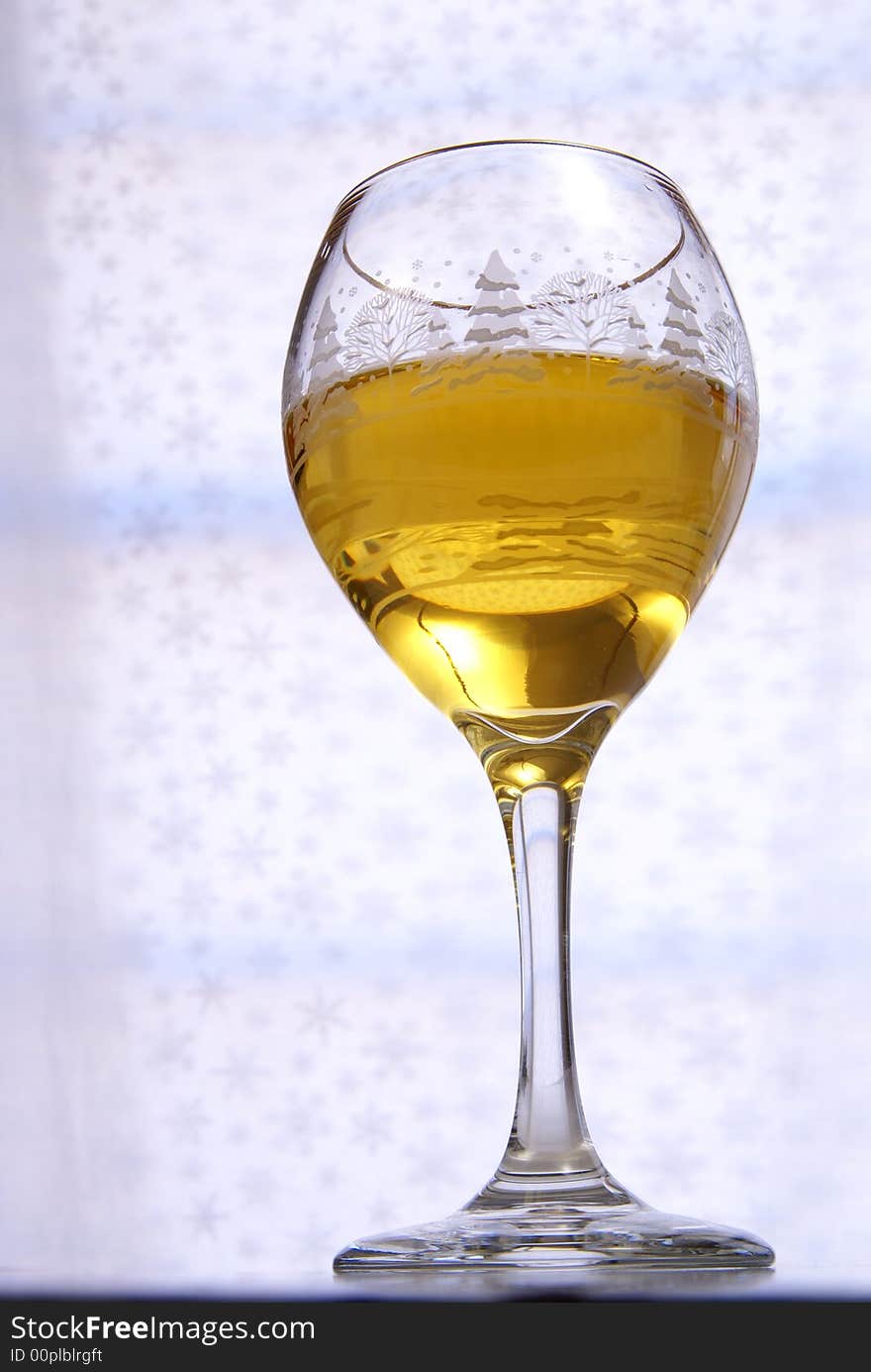 Golden wine in glass from very low perspective. Golden wine in glass from very low perspective