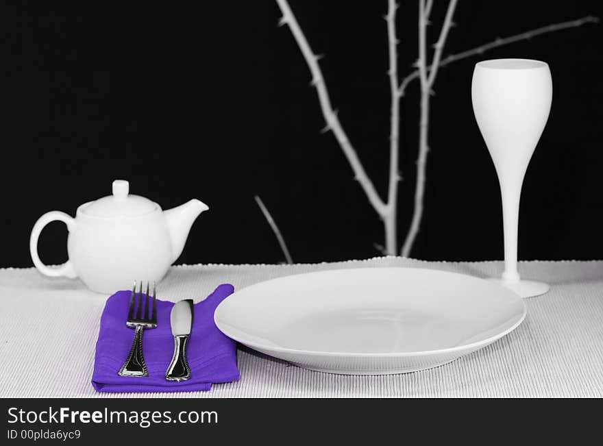 A modern dinner table set for one
