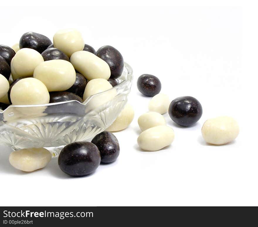 Group of black and white sweet candies isolated over white background