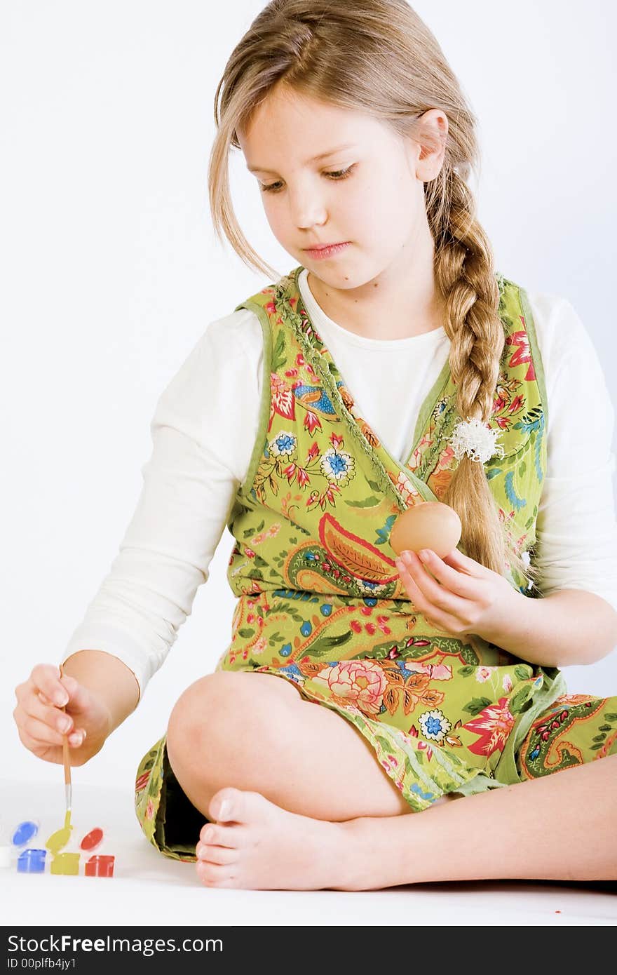 Young Girl Painting Eggs For Easter