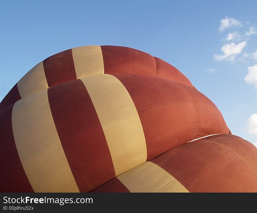 Detail of brown and beige hot-air balloon, halfway inflated. Detail of brown and beige hot-air balloon, halfway inflated.