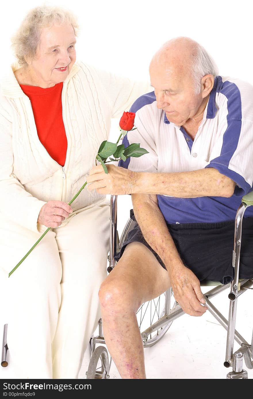 Wife giving handicap husband a rose vertical isolated on white