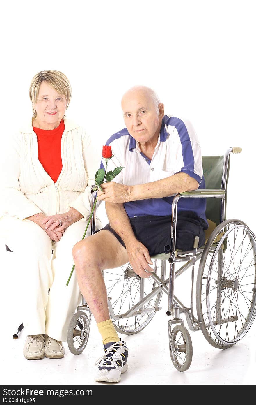 Handicap senior couple isolated on white