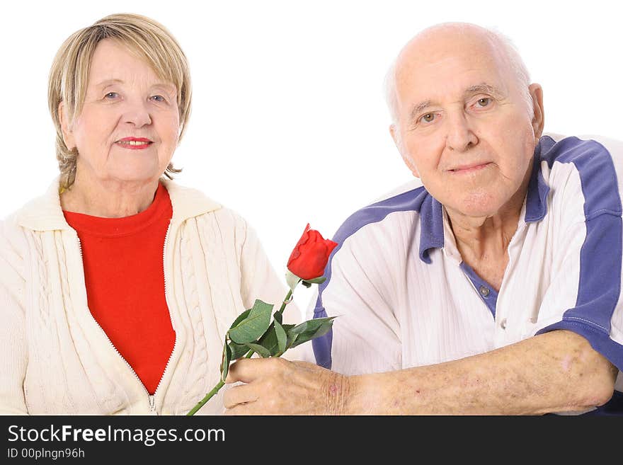 Happy seniors with Valentines rose isolated on white