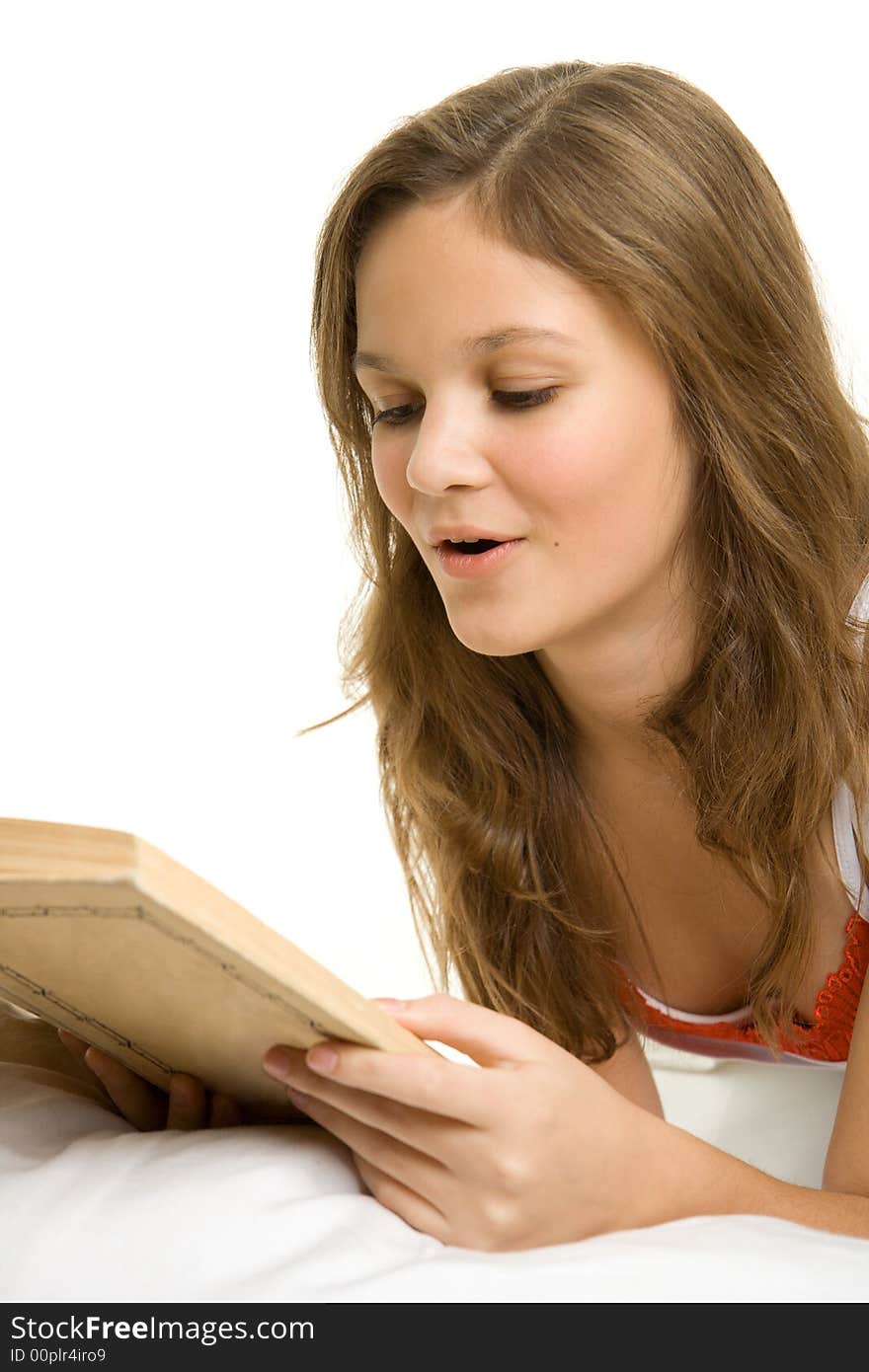 Girl reading book in bed