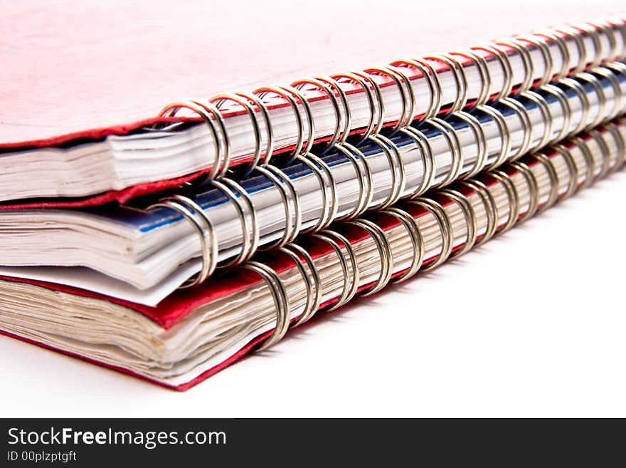 A stack of three lesson plan books with metal coil binding.