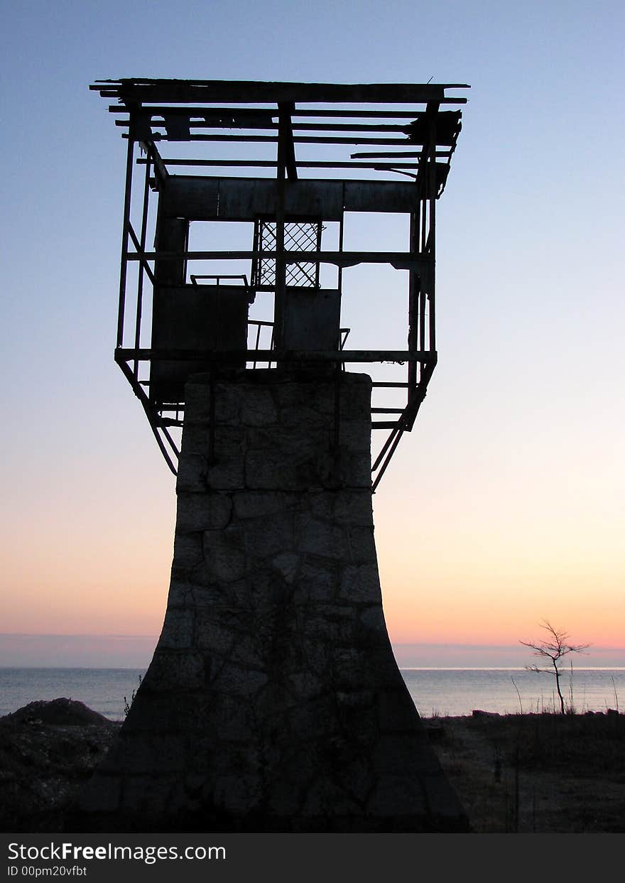 Old tower on the sunset beach. Old tower on the sunset beach