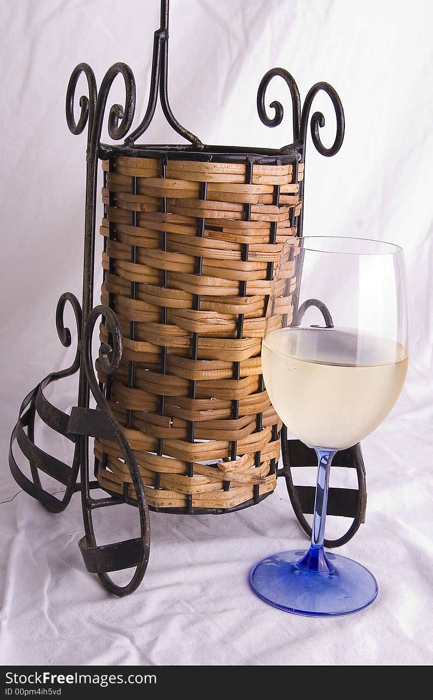 Wine glass and wine bottle holder with white background.