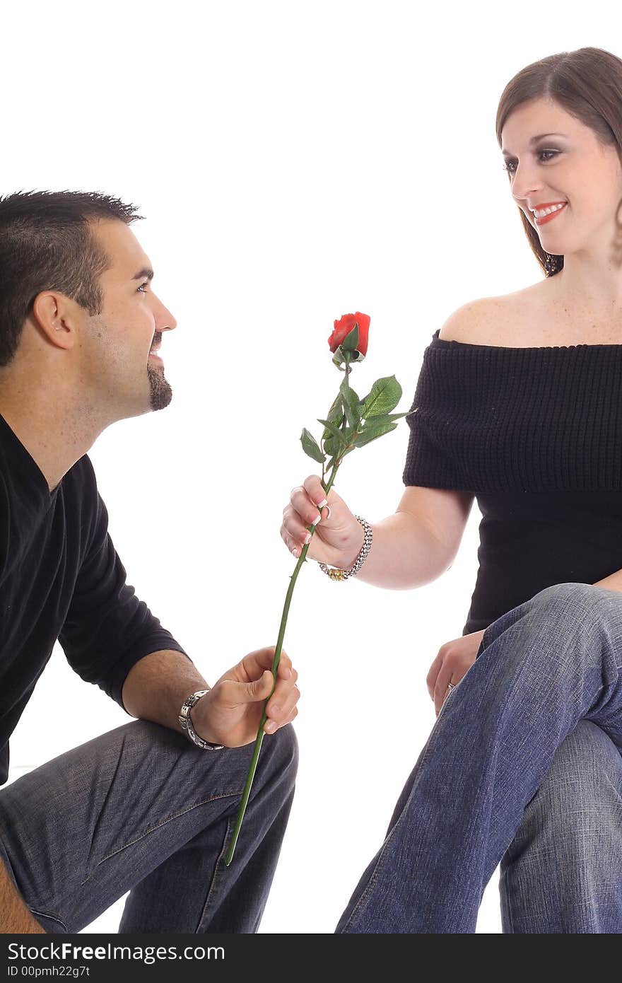 Latino man giving woman a rose isolated on white