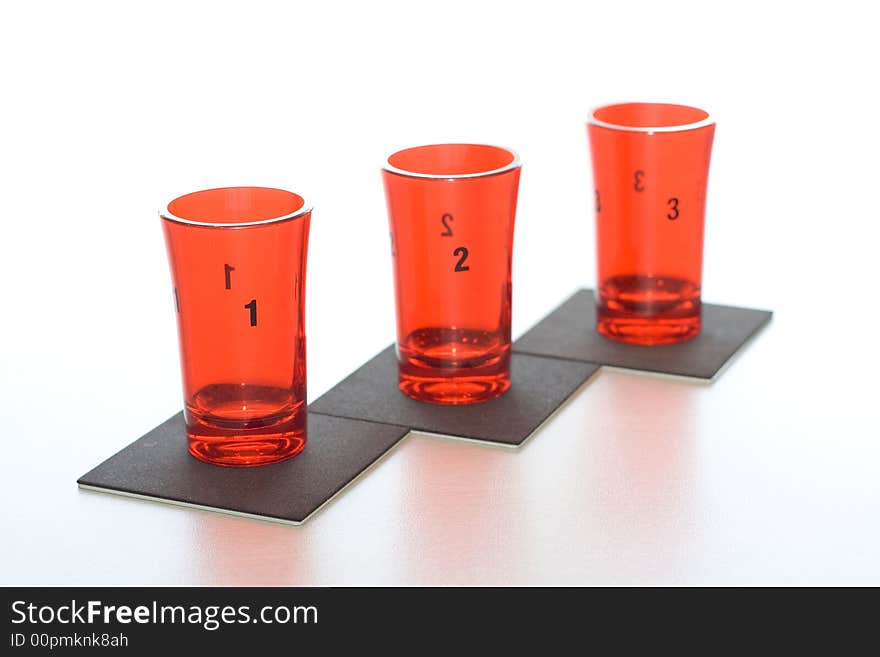 Three red glass numbered on black supports.