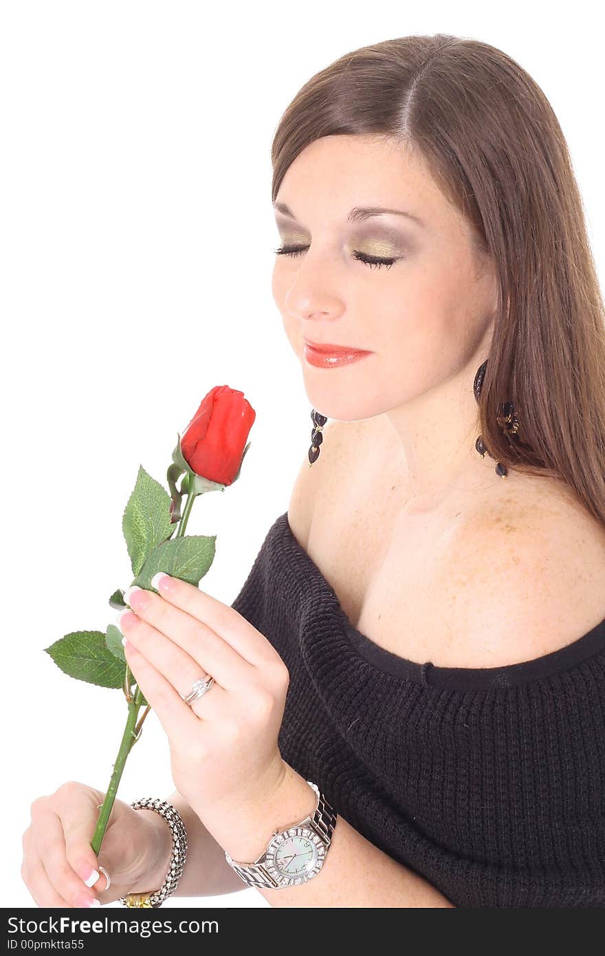 Brunette beauty smelling a rose