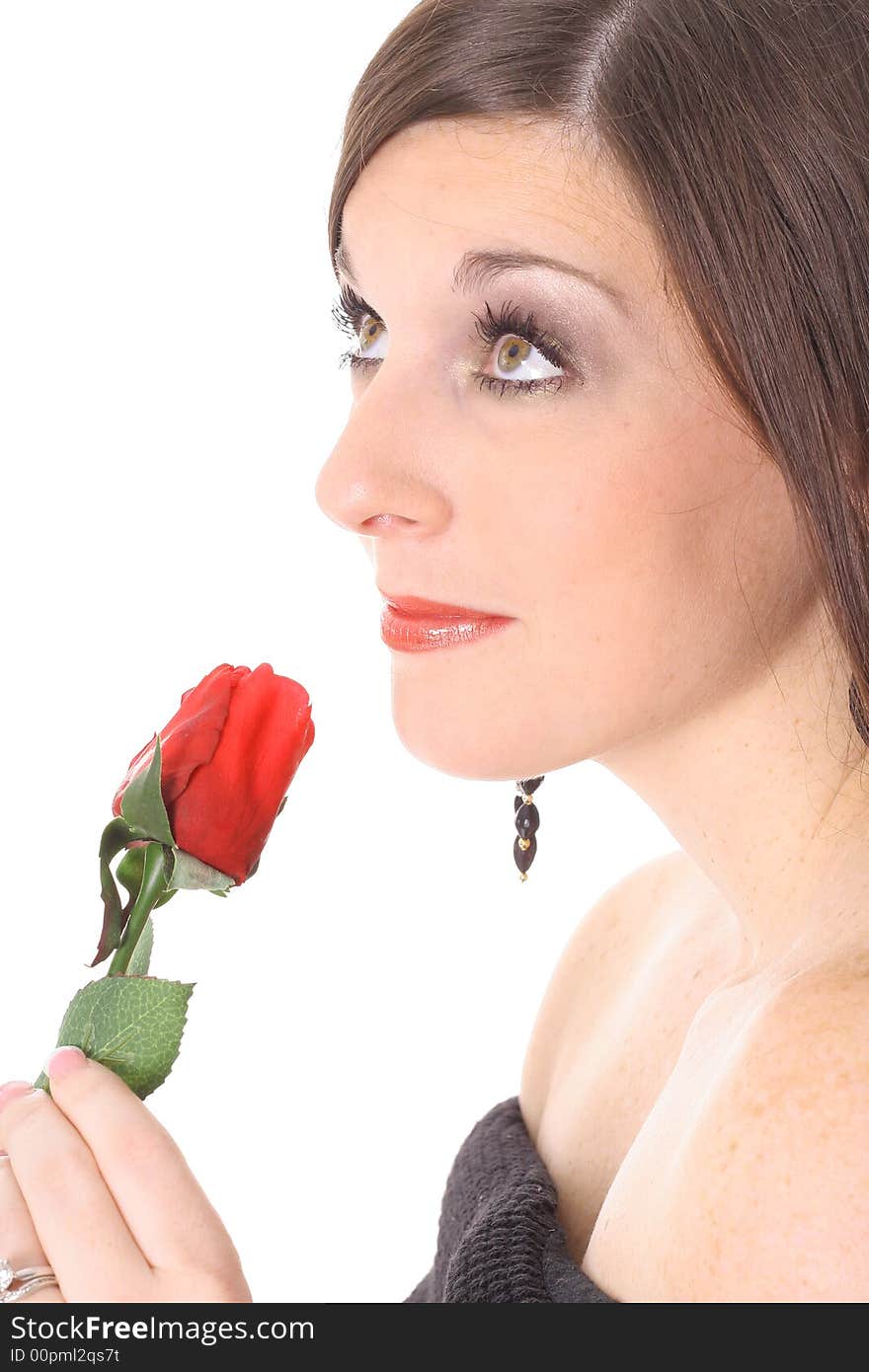 Brunette smelling a rose looking up isolated on white