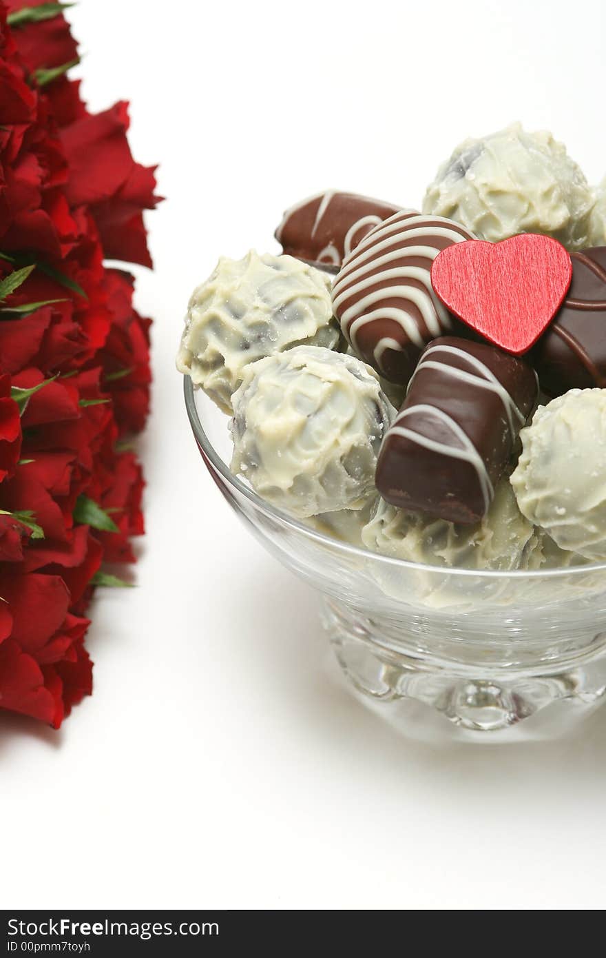 Valentine heart with candies and red rose on white background. Valentine heart with candies and red rose on white background.